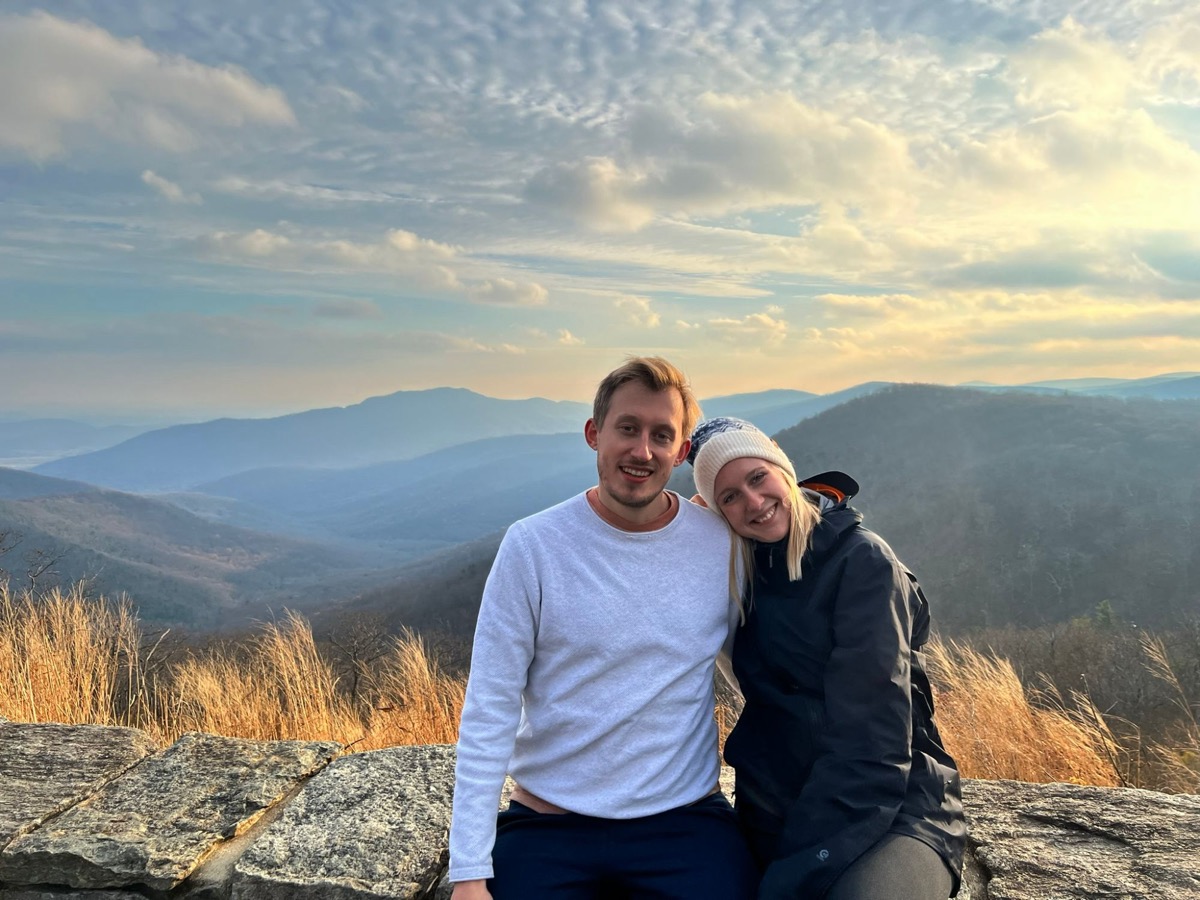 Patricia and Nikolas on a mountain overlook at sunset