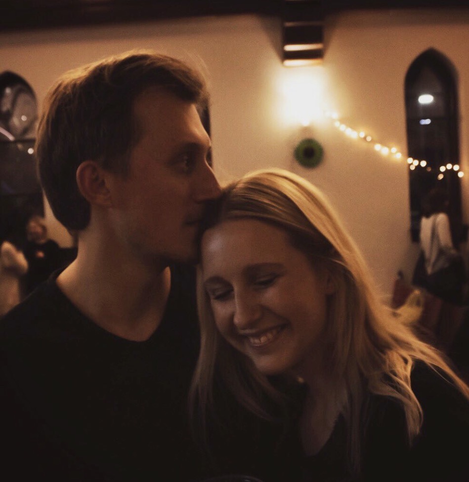 Patricia and Nikolas, smiling together at an evening party